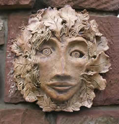 Green Man wall plaques with Roma Short at Greystoke Cycle Cafe